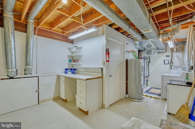 unfinished below grade area with light floors, water heater, and washing machine and clothes dryer