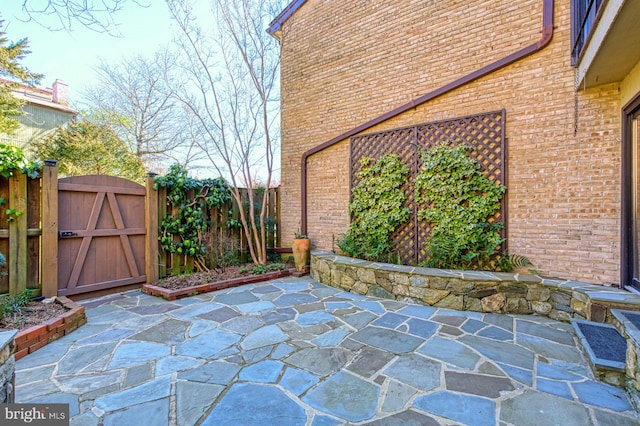 view of patio featuring a gate and fence