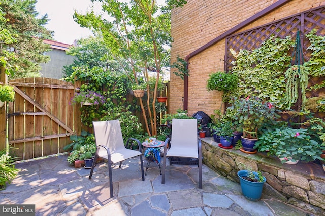 view of patio featuring a gate and fence