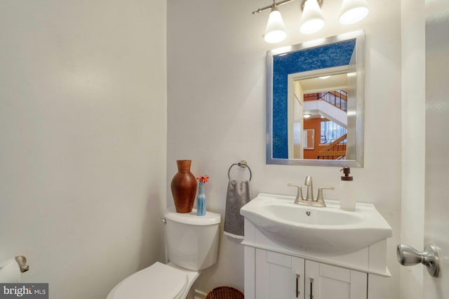 bathroom featuring toilet and vanity