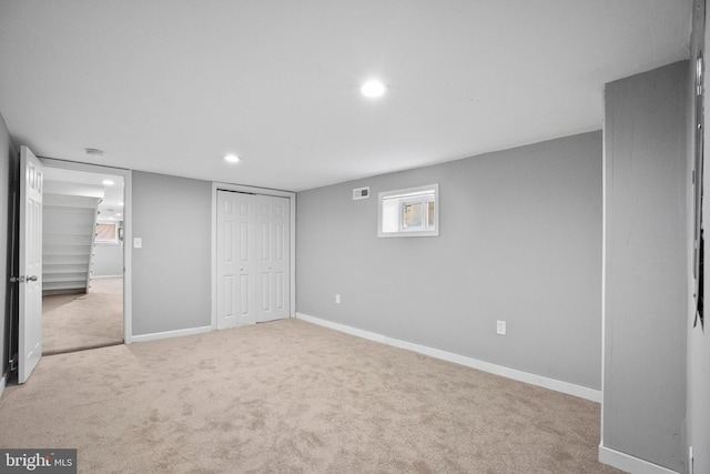 unfurnished bedroom with light carpet, baseboards, visible vents, a closet, and recessed lighting