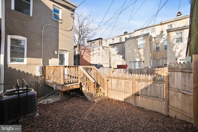 exterior space featuring fence and central AC