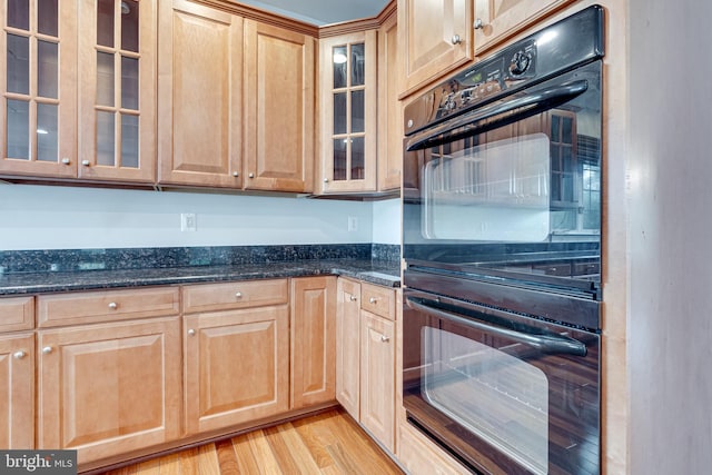 16309 Sandy Ridge Ct, Woodbridge, VA 22191 - kitchen featuring glass insert cabinets, dark stone counters, light brown cabinets, and light wood-type flooring