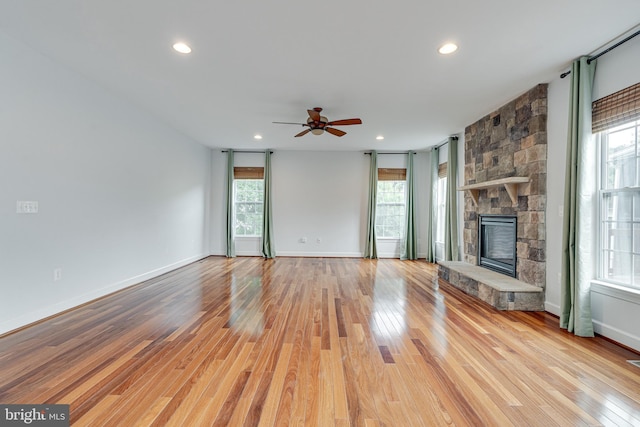 16309 Sandy Ridge Ct, Woodbridge, VA 22191 - unfurnished living room with light wood-style floors, a ceiling fan, recessed lighting, baseboards, and a stone fireplace