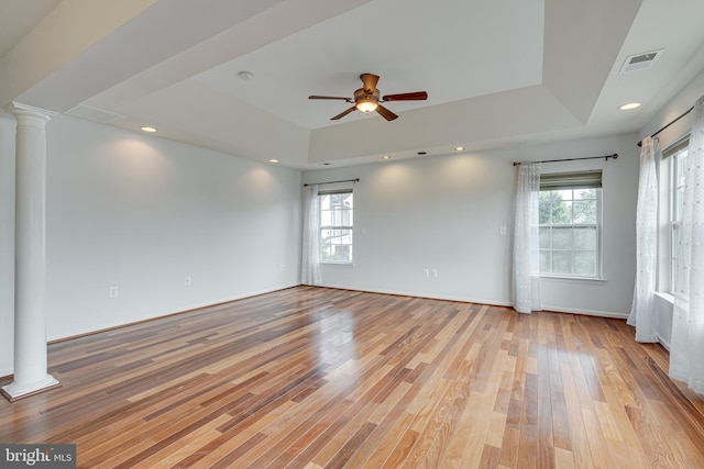 16309 Sandy Ridge Ct, Woodbridge, VA 22191 - unfurnished room with ornate columns, a tray ceiling, a ceiling fan, and healthy amount of natural light
