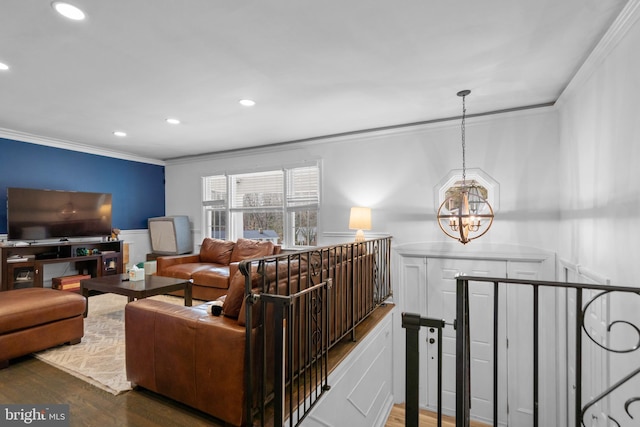 living room with an inviting chandelier, dark wood-style flooring, crown molding, and recessed lighting