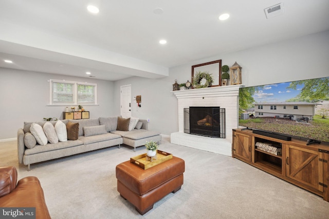 living area with recessed lighting, visible vents, a brick fireplace, light carpet, and baseboards