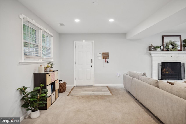 carpeted living area featuring recessed lighting, a fireplace, visible vents, and baseboards