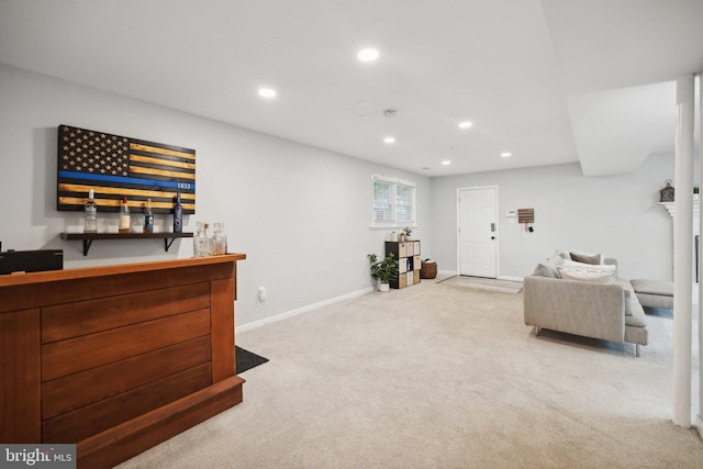 living room with a fireplace, a dry bar, recessed lighting, light colored carpet, and baseboards