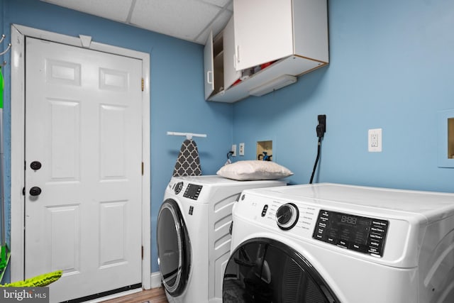 washroom with washing machine and dryer, laundry area, and light wood finished floors