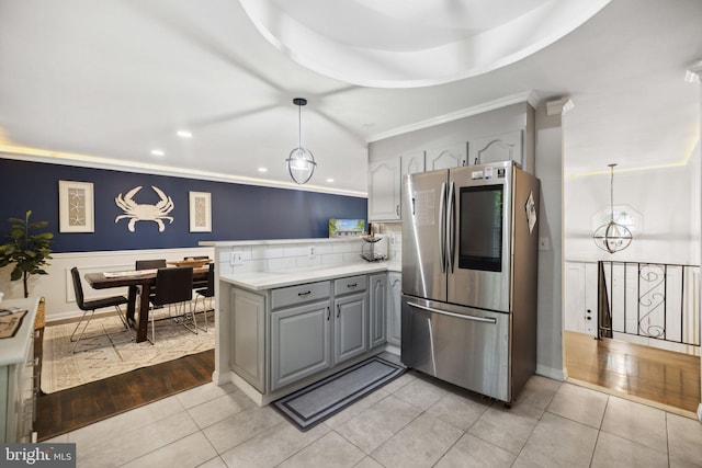 kitchen featuring a peninsula, smart refrigerator, pendant lighting, and gray cabinets