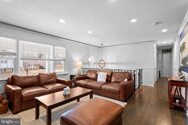 living area featuring ornamental molding, dark wood finished floors, visible vents, and recessed lighting