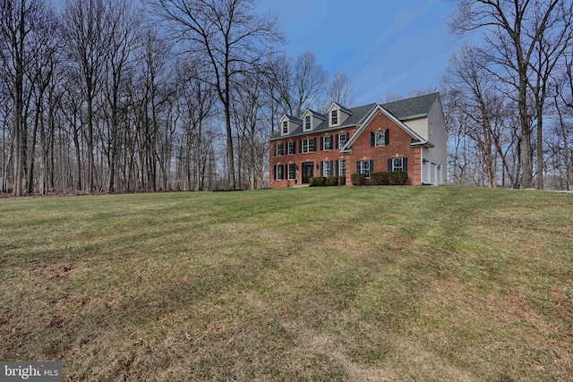 view of front of house with brick siding and a front lawn