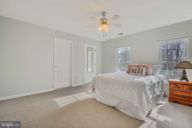 bedroom with visible vents, baseboards, ceiling fan, and carpet flooring