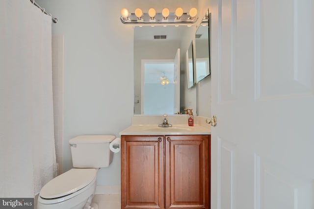 full bathroom with vanity, a shower with shower curtain, visible vents, tile patterned flooring, and toilet