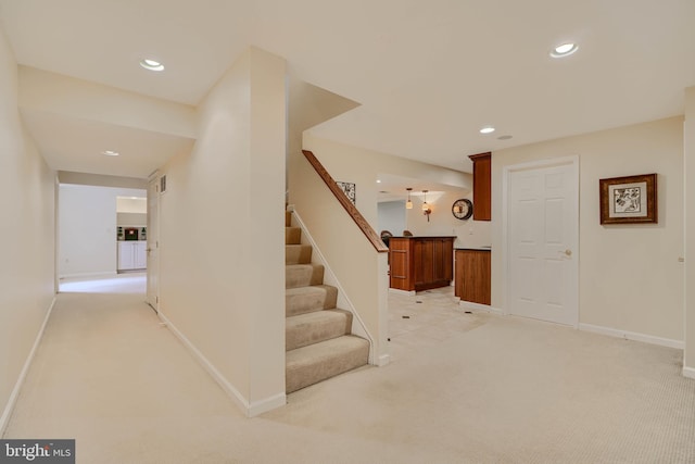 staircase with bar area, recessed lighting, baseboards, and carpet floors