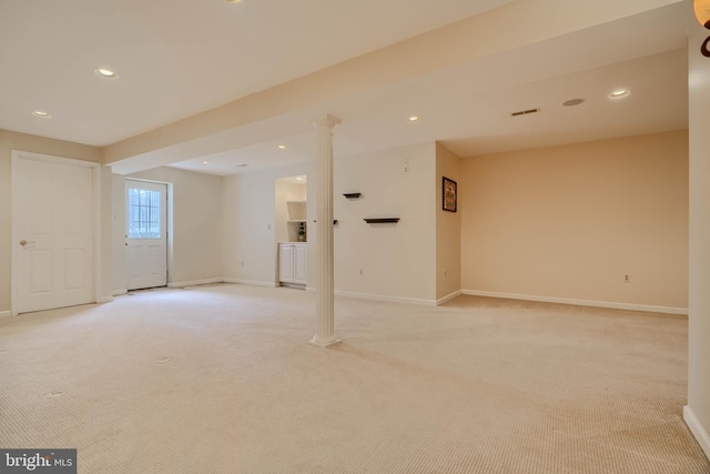 spare room featuring light carpet, recessed lighting, baseboards, and decorative columns