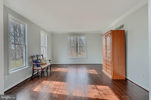 living area with baseboards, dark wood finished floors, and ornamental molding