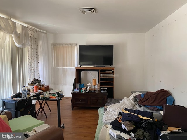 bedroom with visible vents and wood finished floors