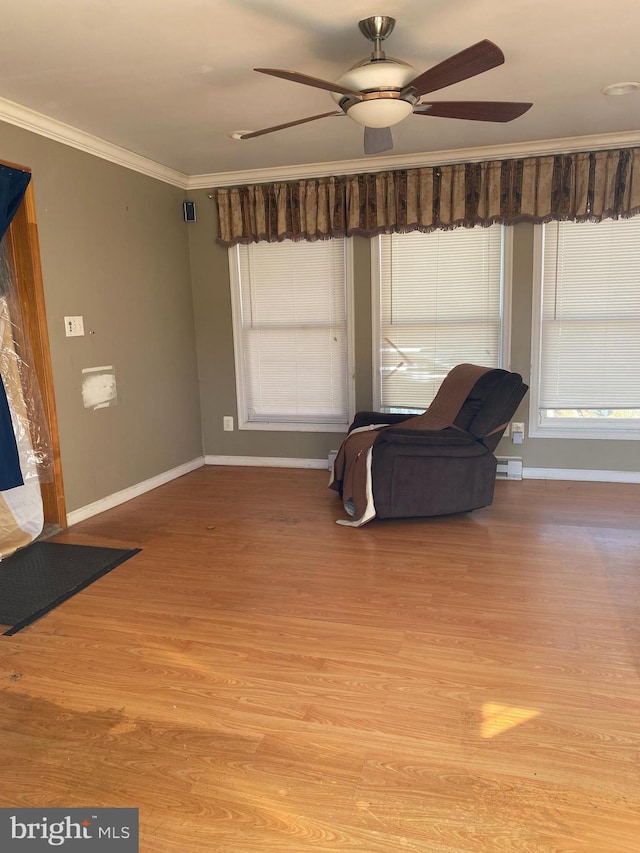 unfurnished room with ceiling fan, light wood-style flooring, a wealth of natural light, and ornamental molding