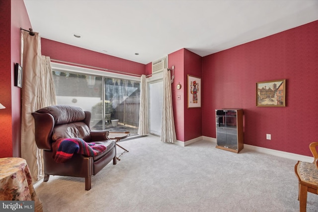 sitting room featuring baseboards and carpet flooring