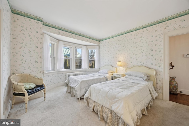 bedroom with carpet floors, radiator, baseboards, and wallpapered walls