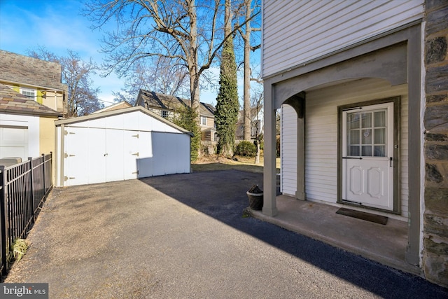 exterior space with a storage shed and fence