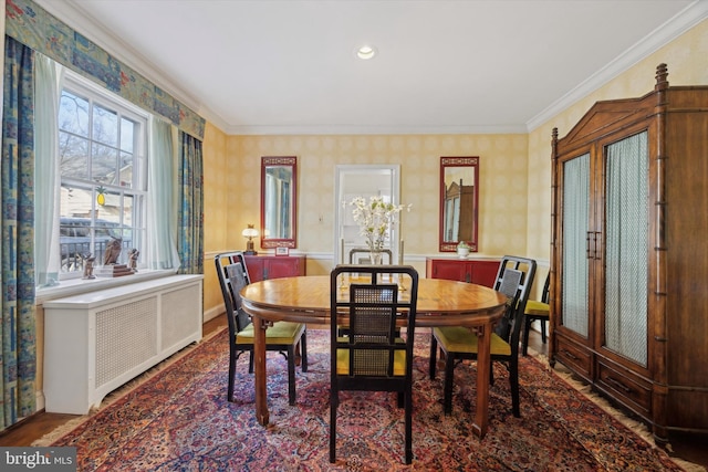 dining space featuring french doors, radiator heating unit, and crown molding