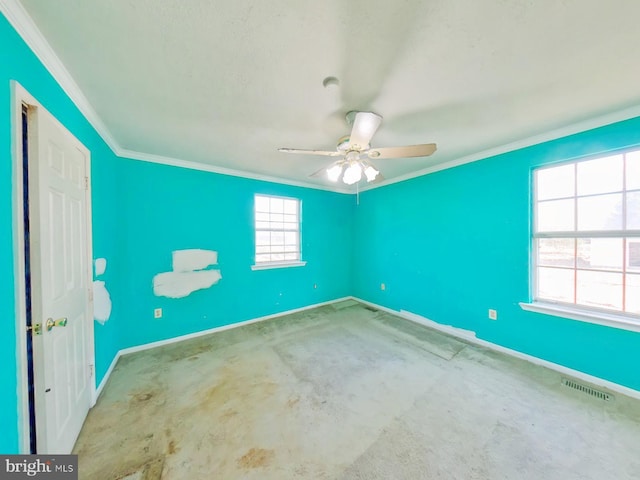 empty room featuring visible vents, crown molding, baseboards, and ceiling fan