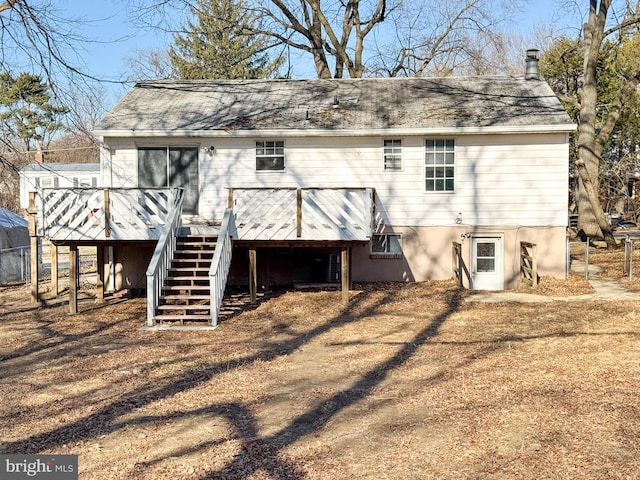 back of house with a wooden deck and stairs