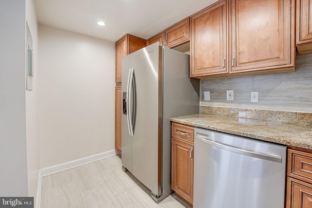 kitchen featuring stainless steel appliances, brown cabinets, and decorative backsplash