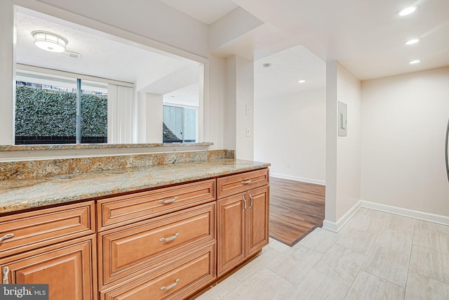 bathroom featuring recessed lighting, vanity, and baseboards