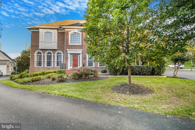 view of front of property with brick siding and a front yard