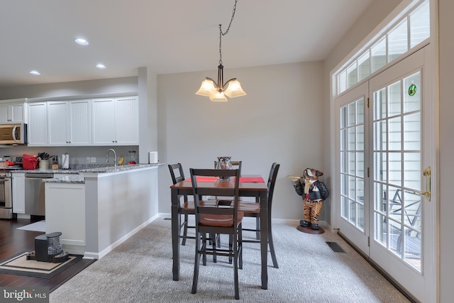 dining room featuring plenty of natural light, visible vents, baseboards, and recessed lighting