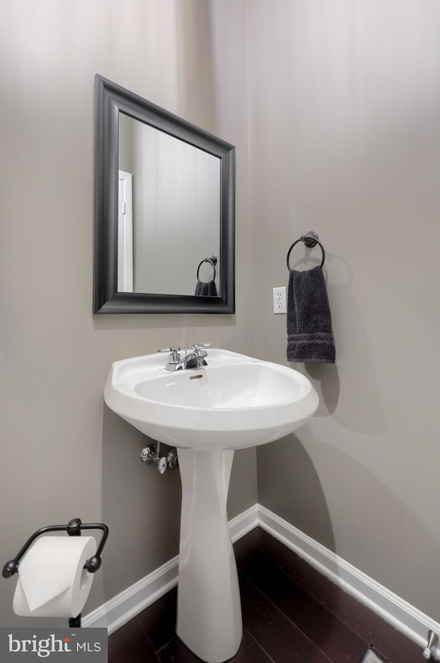 bathroom featuring baseboards and wood finished floors