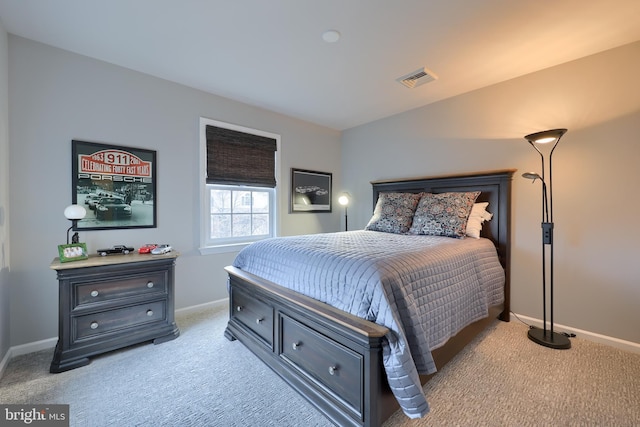 bedroom featuring light colored carpet, visible vents, and baseboards