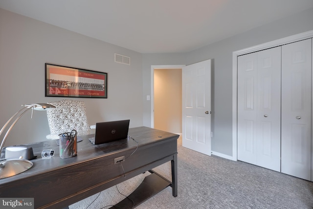 office featuring carpet flooring, visible vents, and baseboards