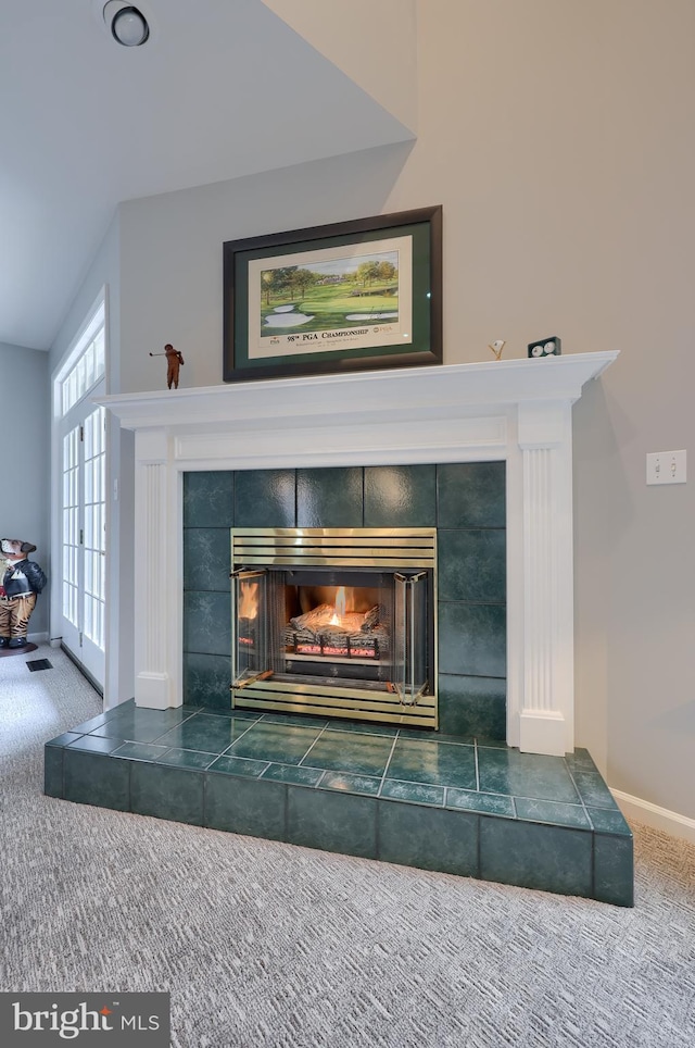 details with carpet, baseboards, and a tiled fireplace