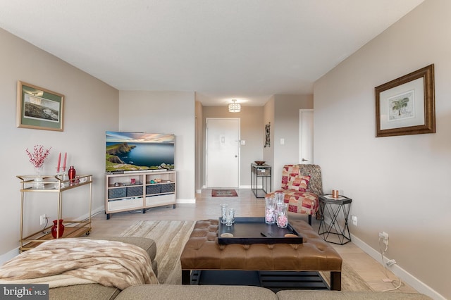 living area with light wood-type flooring and baseboards