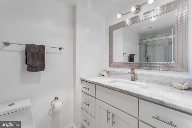 full bath featuring visible vents, toilet, vanity, and a shower stall