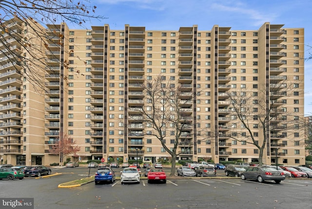 view of building exterior featuring uncovered parking