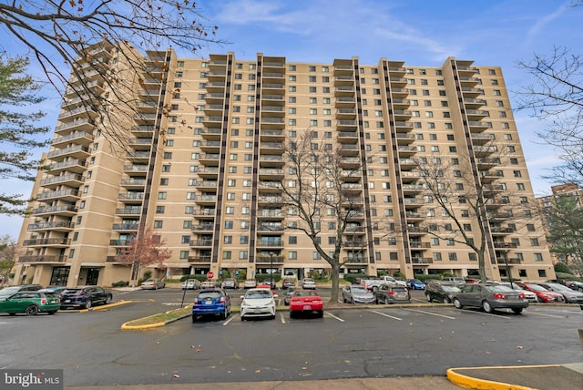 view of building exterior featuring uncovered parking