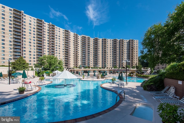 pool featuring a patio area and a view of city