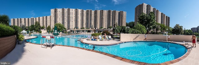 community pool featuring a view of city and a patio