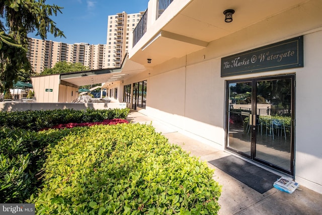 entrance to property with a city view and stucco siding