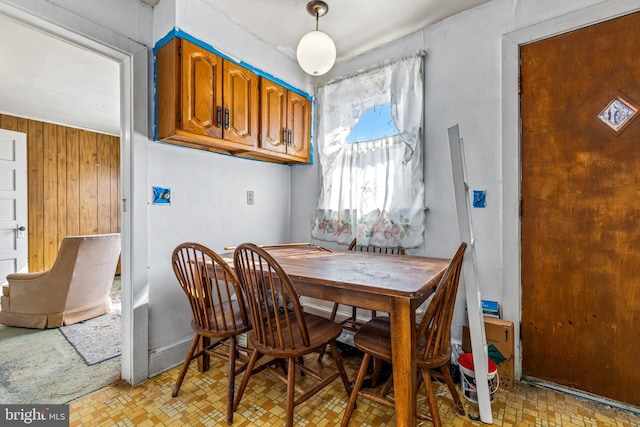 dining area featuring wooden walls