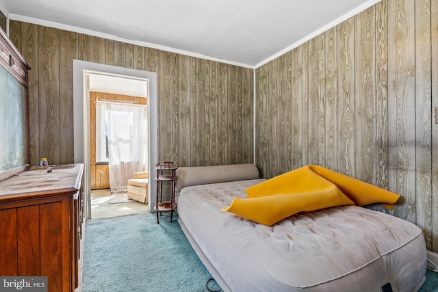 bedroom featuring carpet floors, ornamental molding, and wooden walls