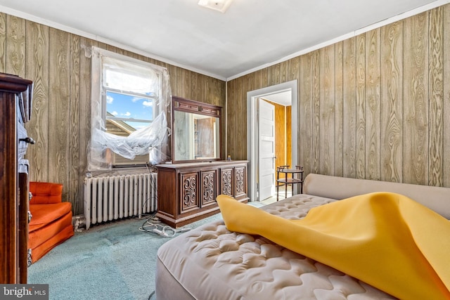 living area featuring ornamental molding, carpet, wood walls, and radiator heating unit