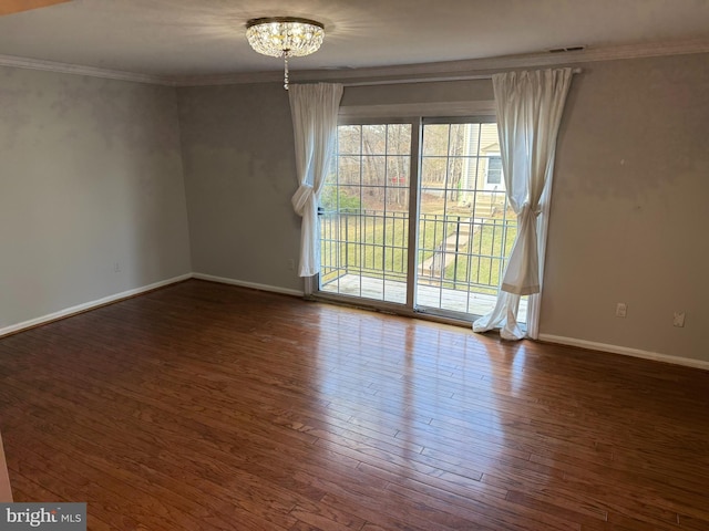 empty room with plenty of natural light, crown molding, baseboards, and wood finished floors