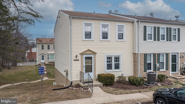 townhome / multi-family property with entry steps and central AC unit